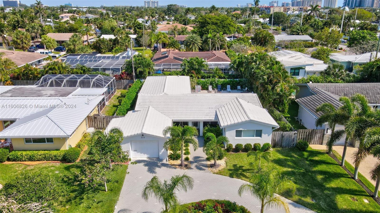 an aerial view of multiple houses with a yard