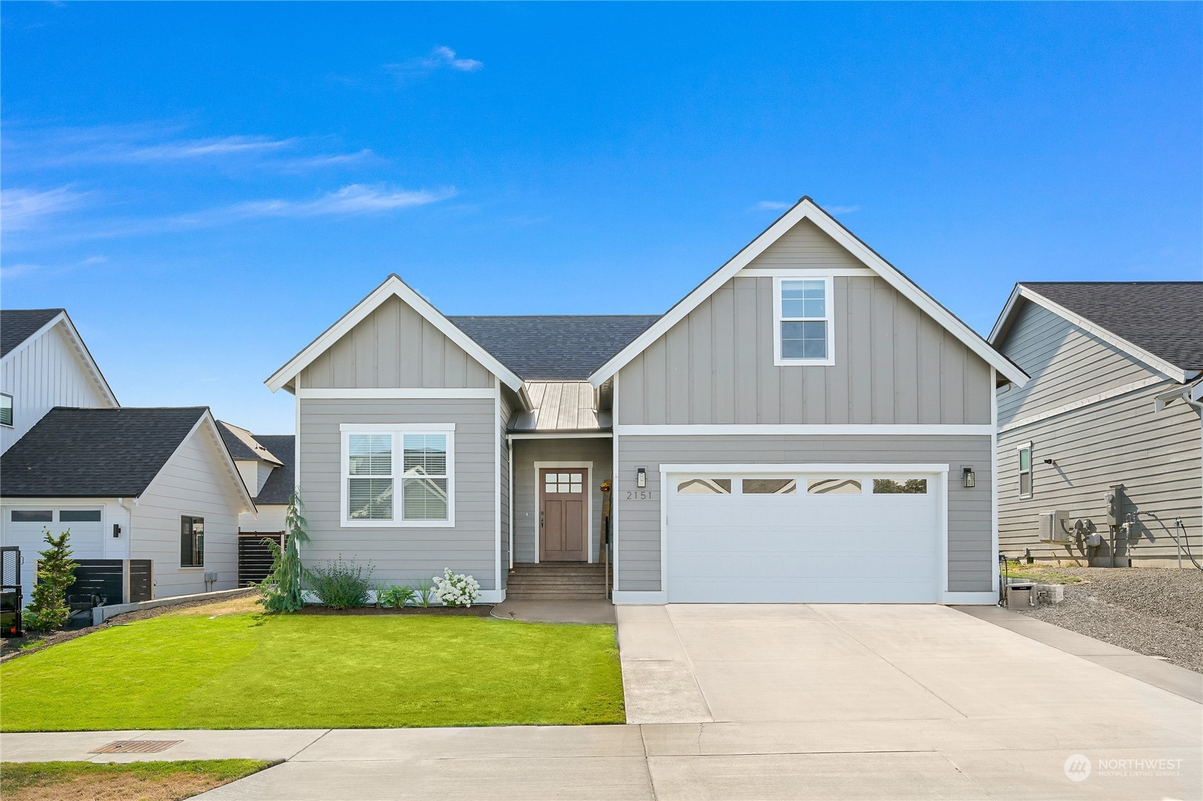 a view of a house with a yard and a garage