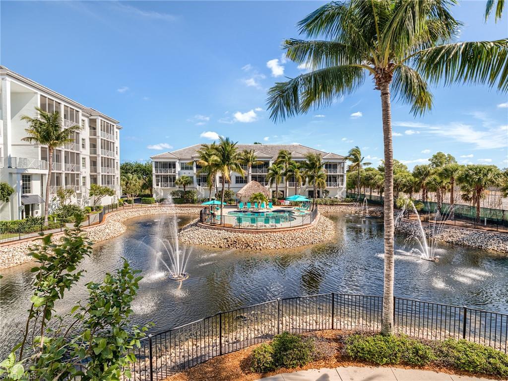 a view of a swimming pool with a lawn chair and palm trees