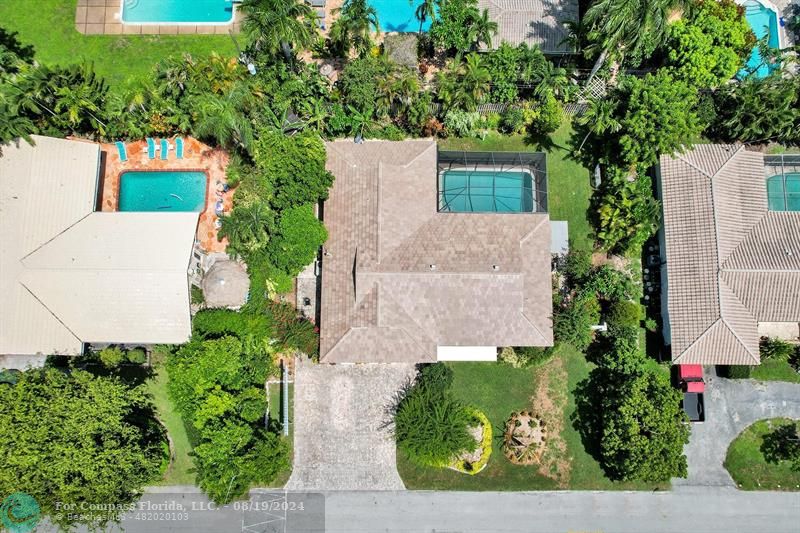 an aerial view of a house with a yard and garden