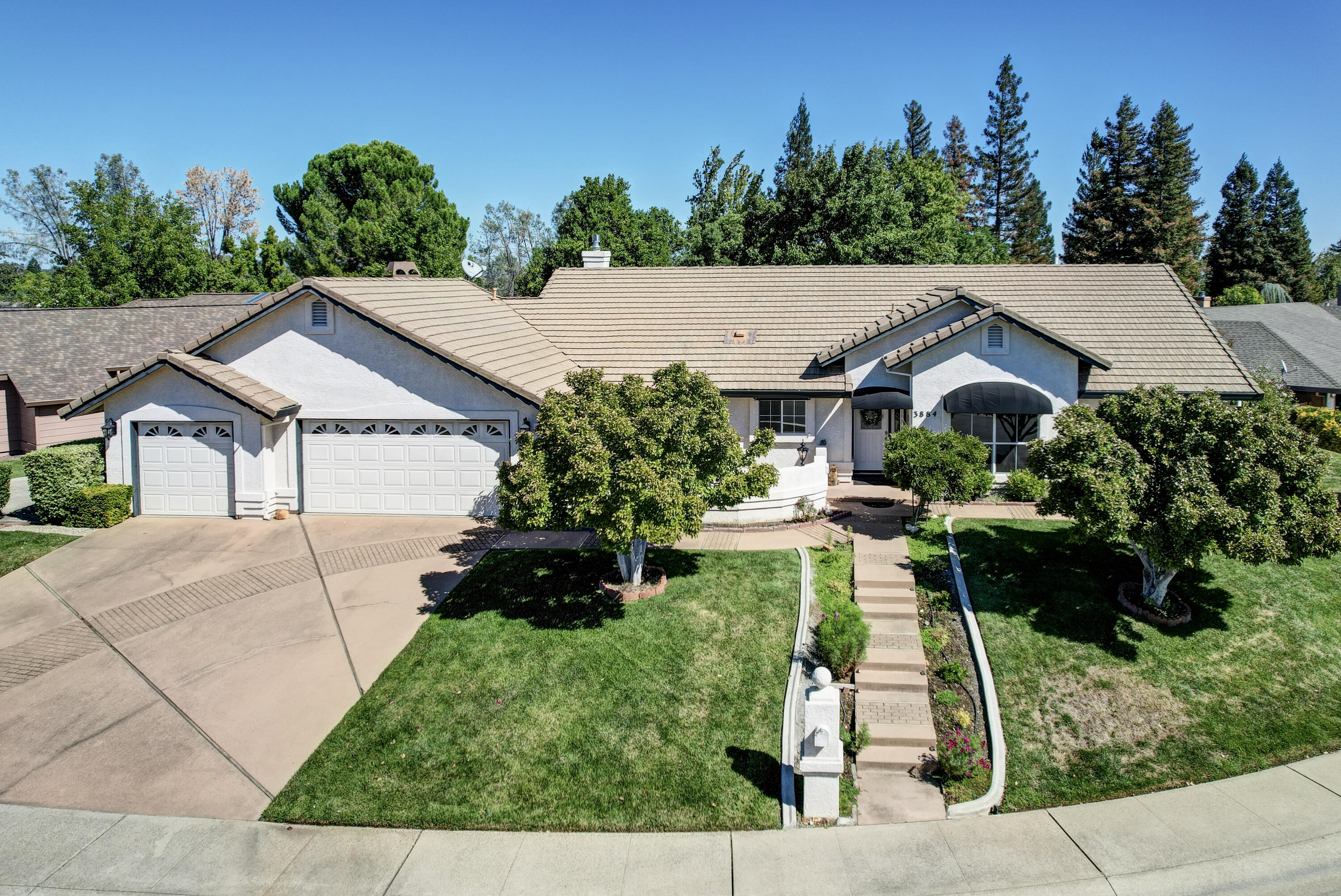 a aerial view of a house with a yard and a sitting area