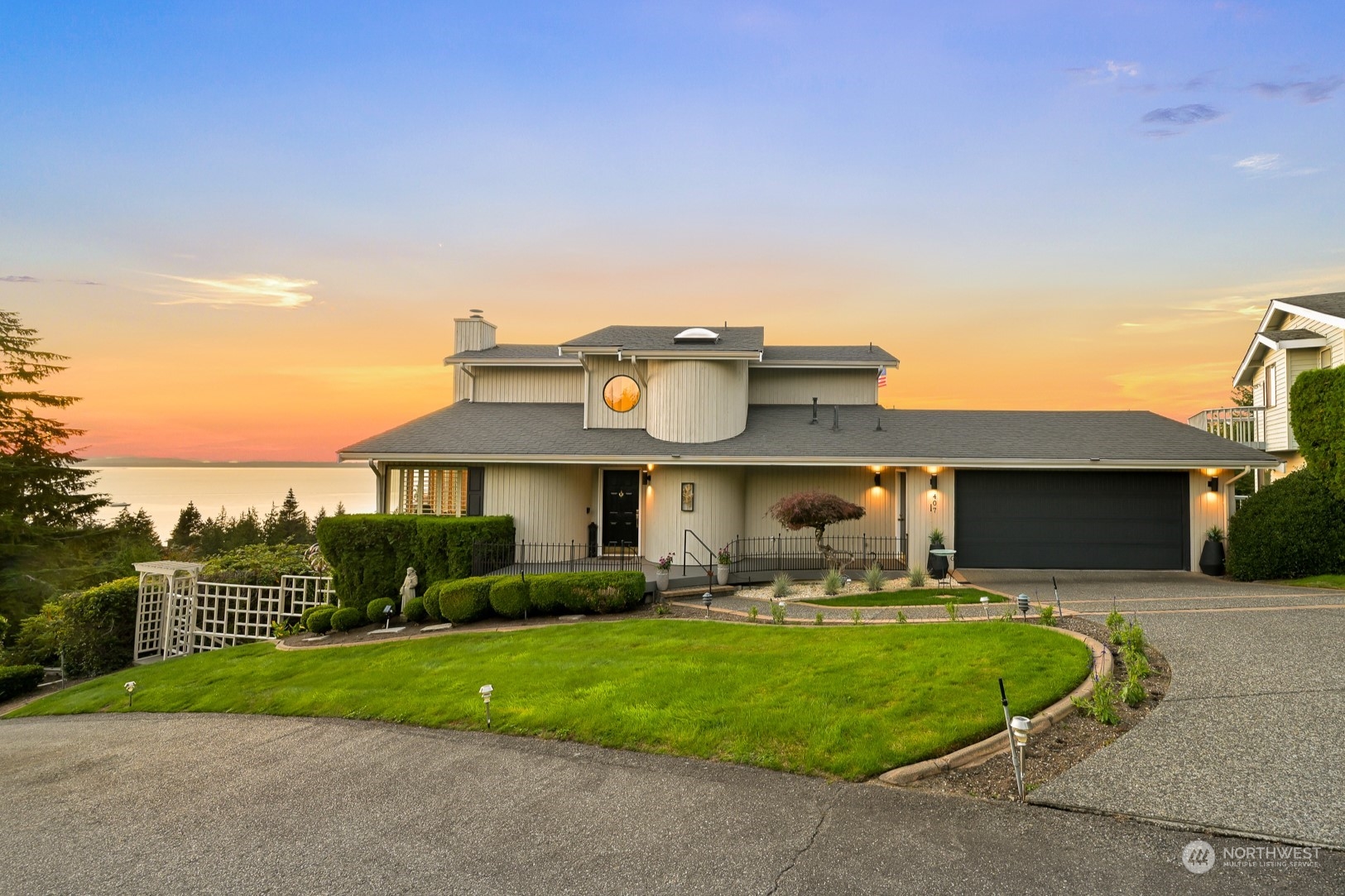 a view of a house with a patio and a yard