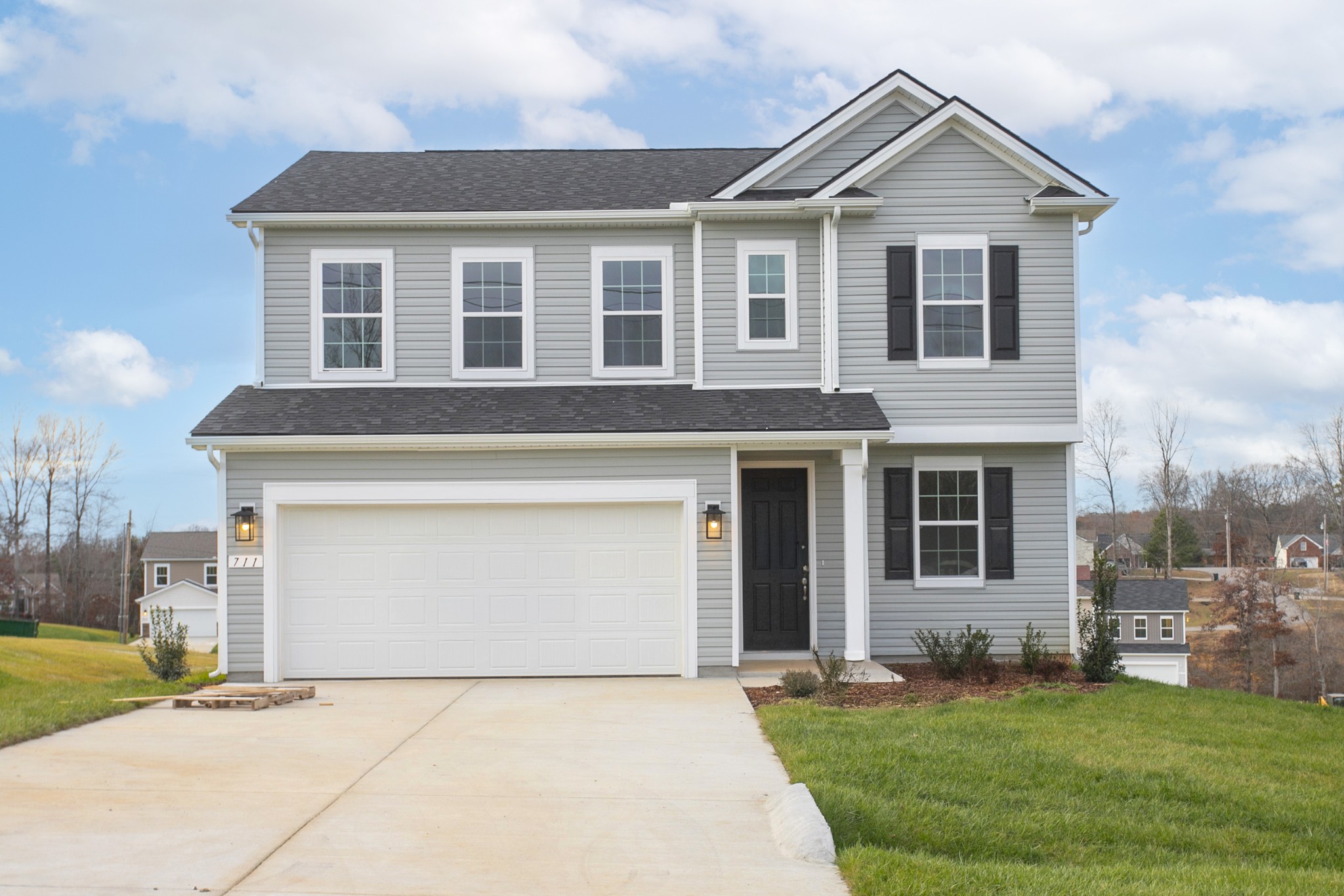 a front view of a house with a yard and garage