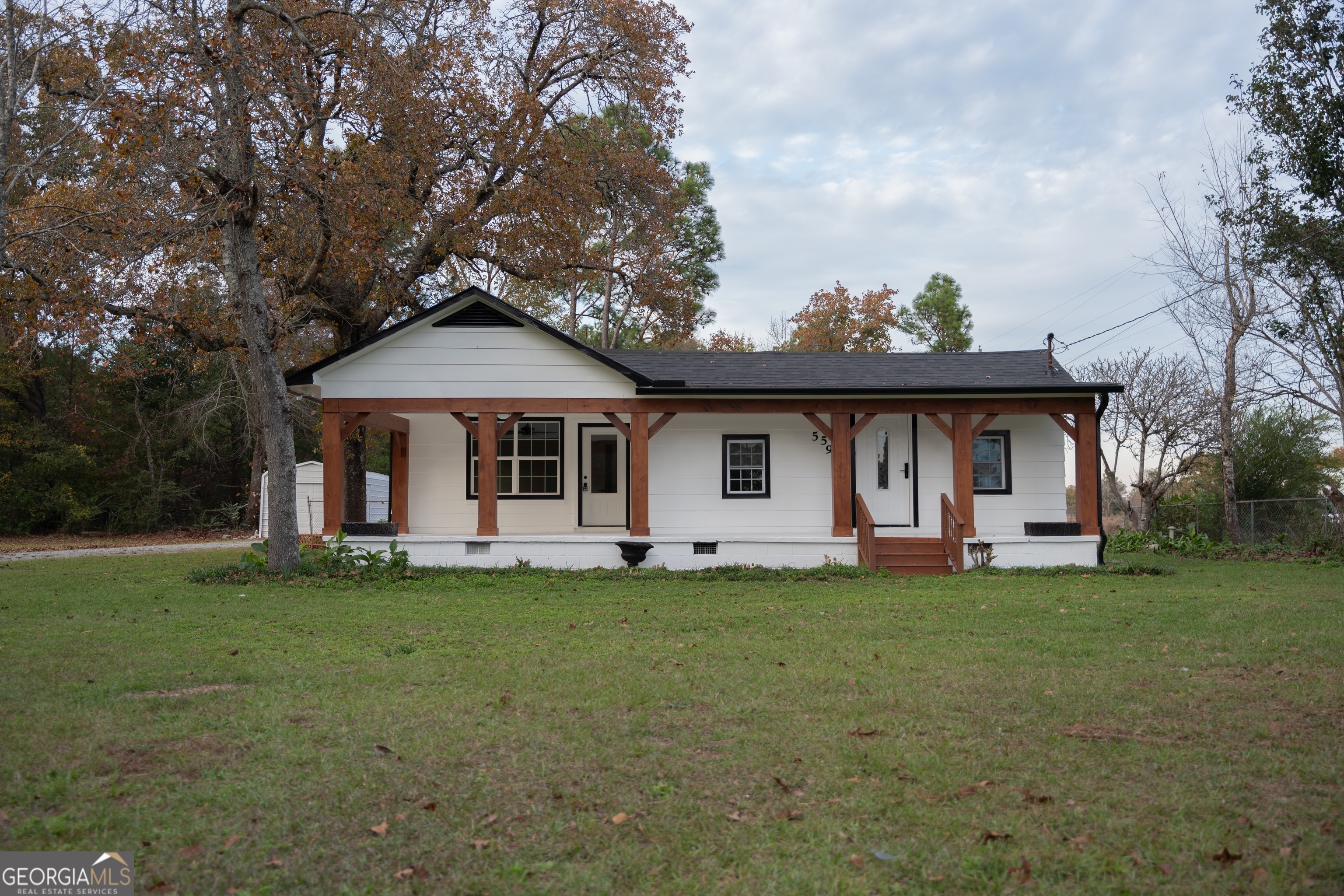 a front view of a house with a garden