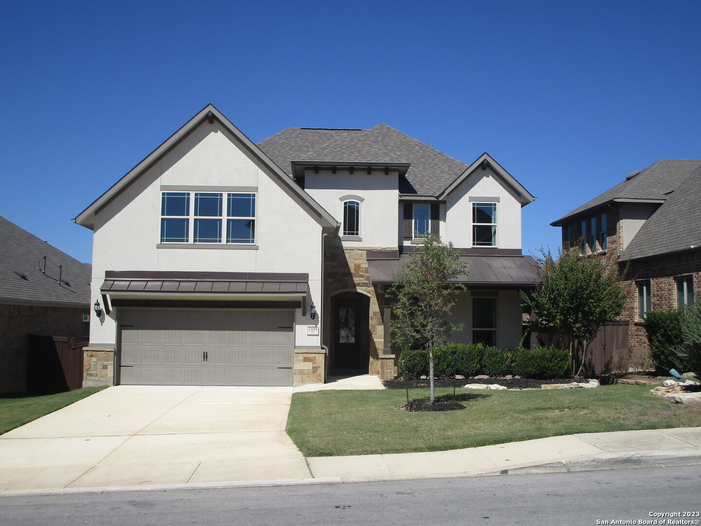 a front view of a house with a yard and garage