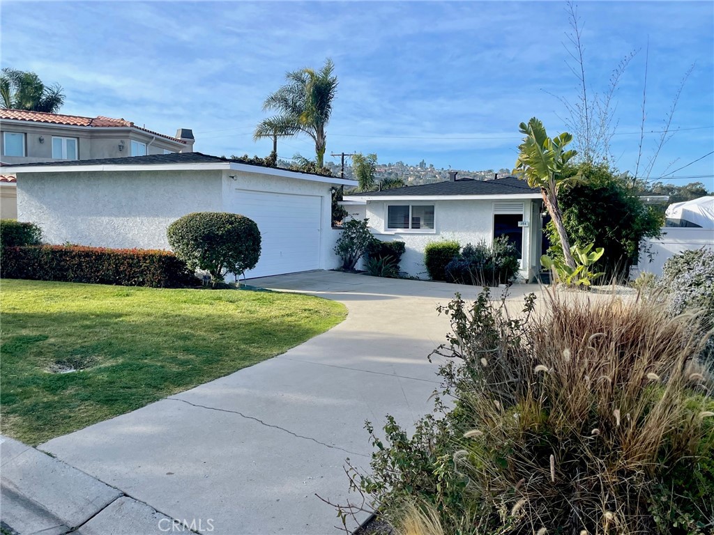 a view of house with yard and outdoor space