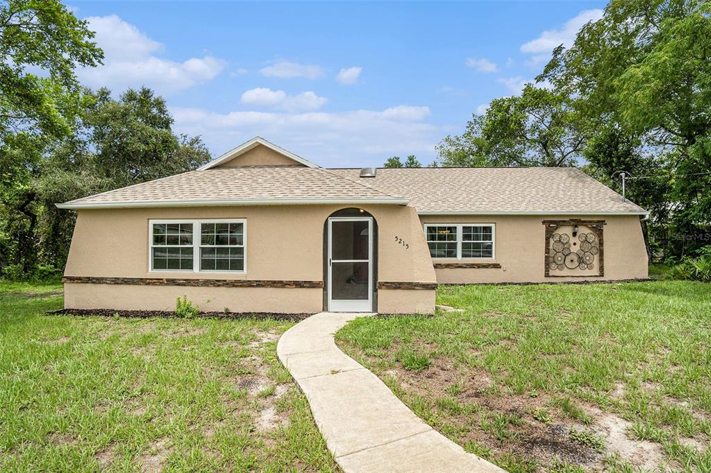 a front view of a house with yard