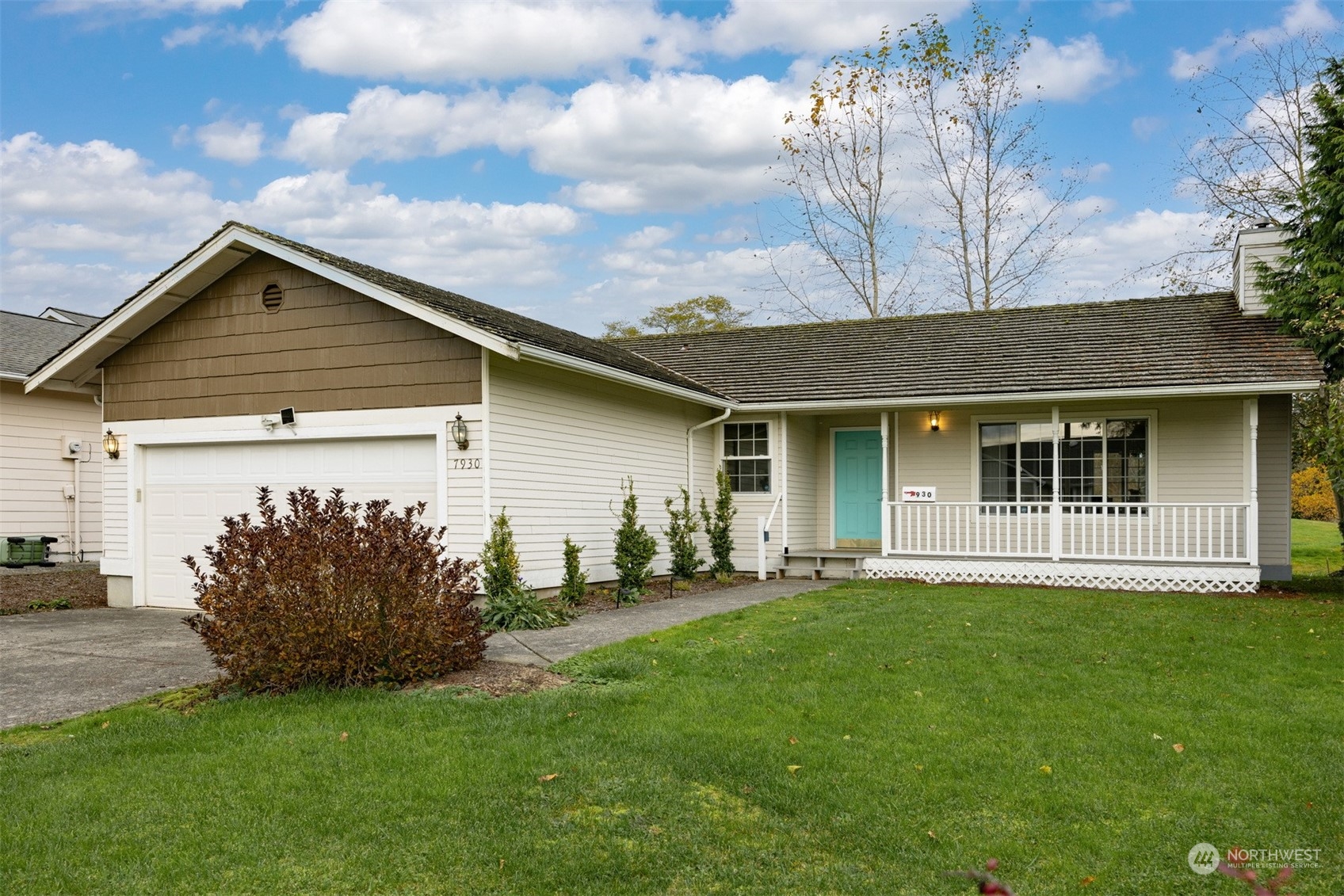 a front view of a house with a garden