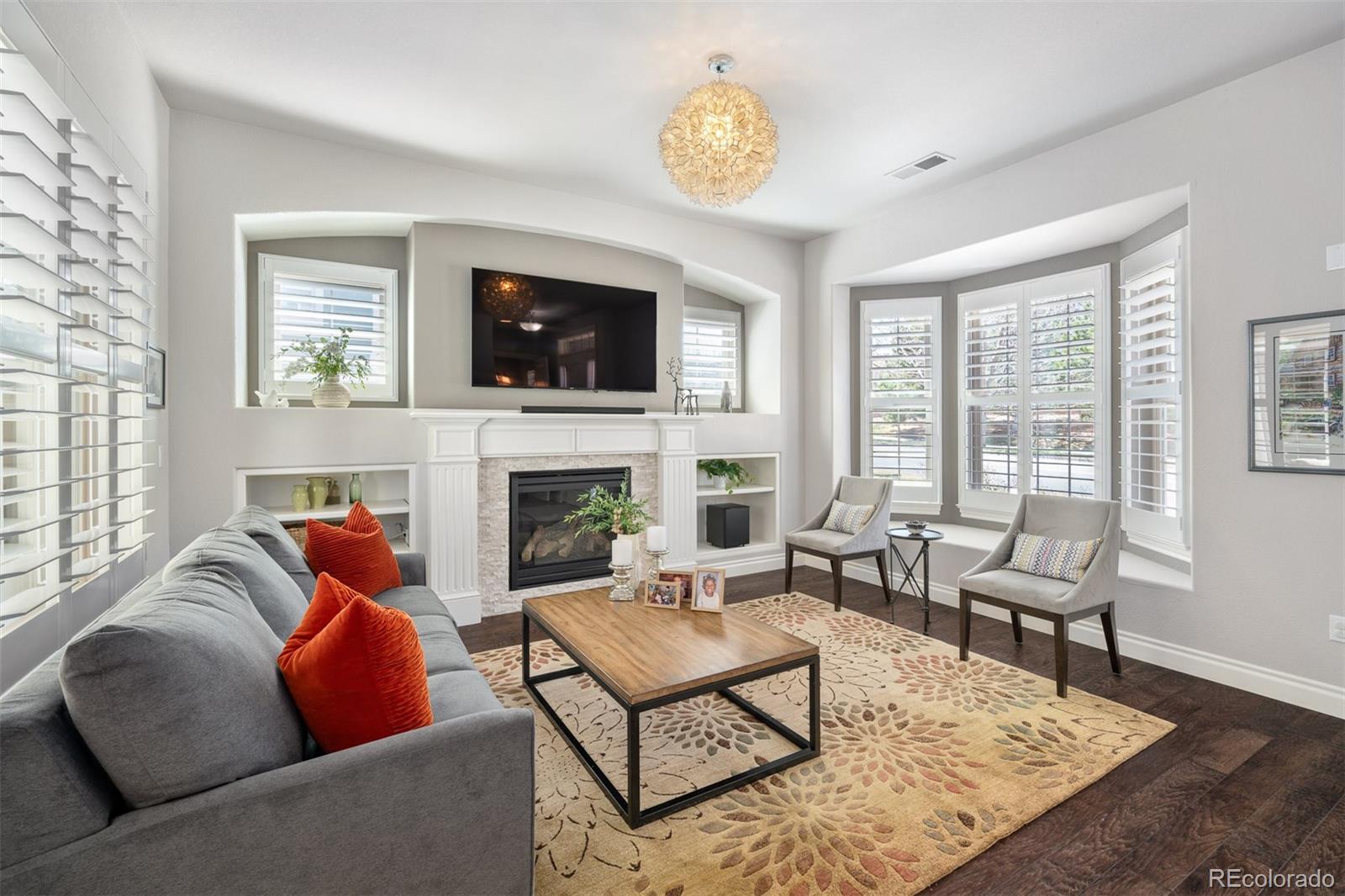 a living room with furniture fireplace and flat screen tv