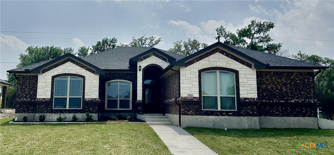 a front view of a house with a yard