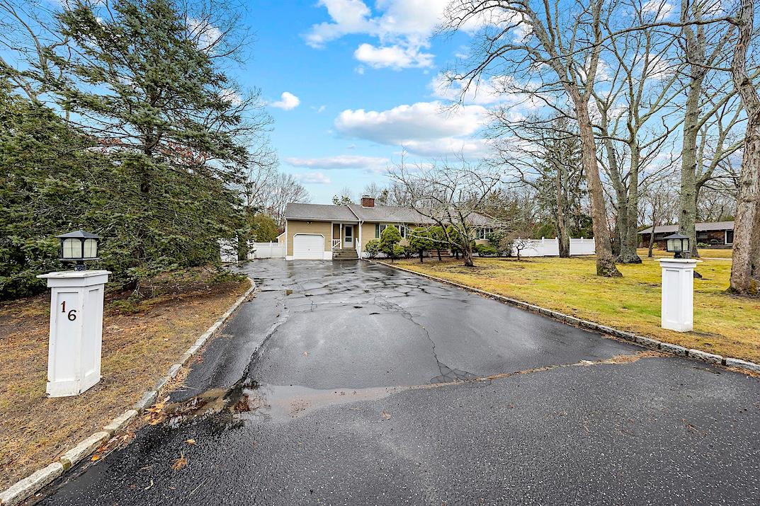 View of front of home featuring a front lawn and a garage