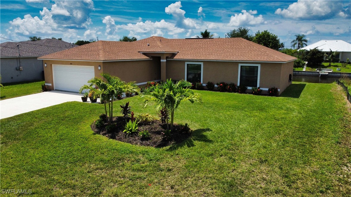 a front view of a house with a garden