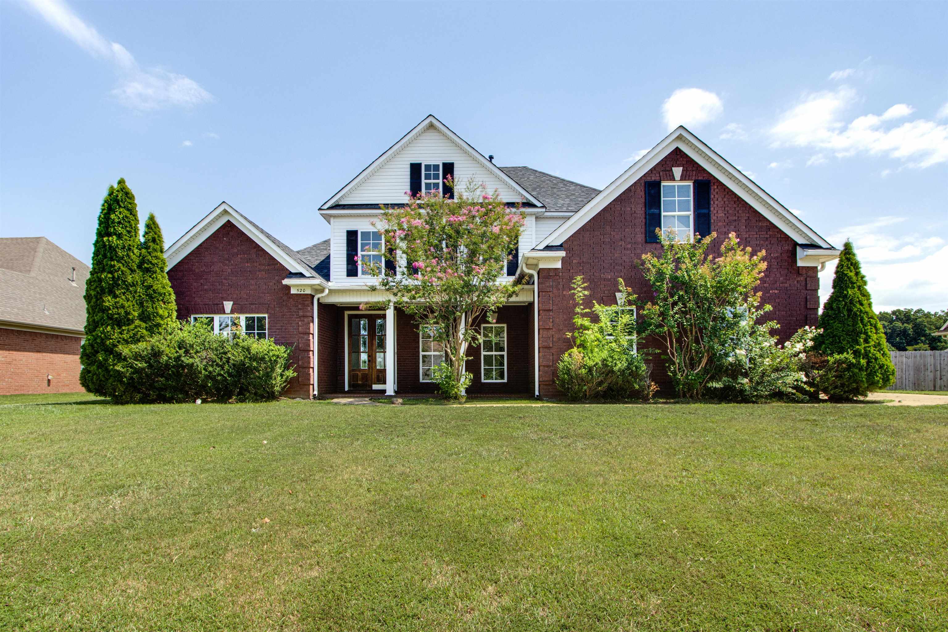 a front view of a house with a yard