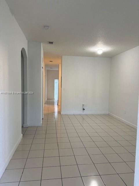 a view of an empty room and a window