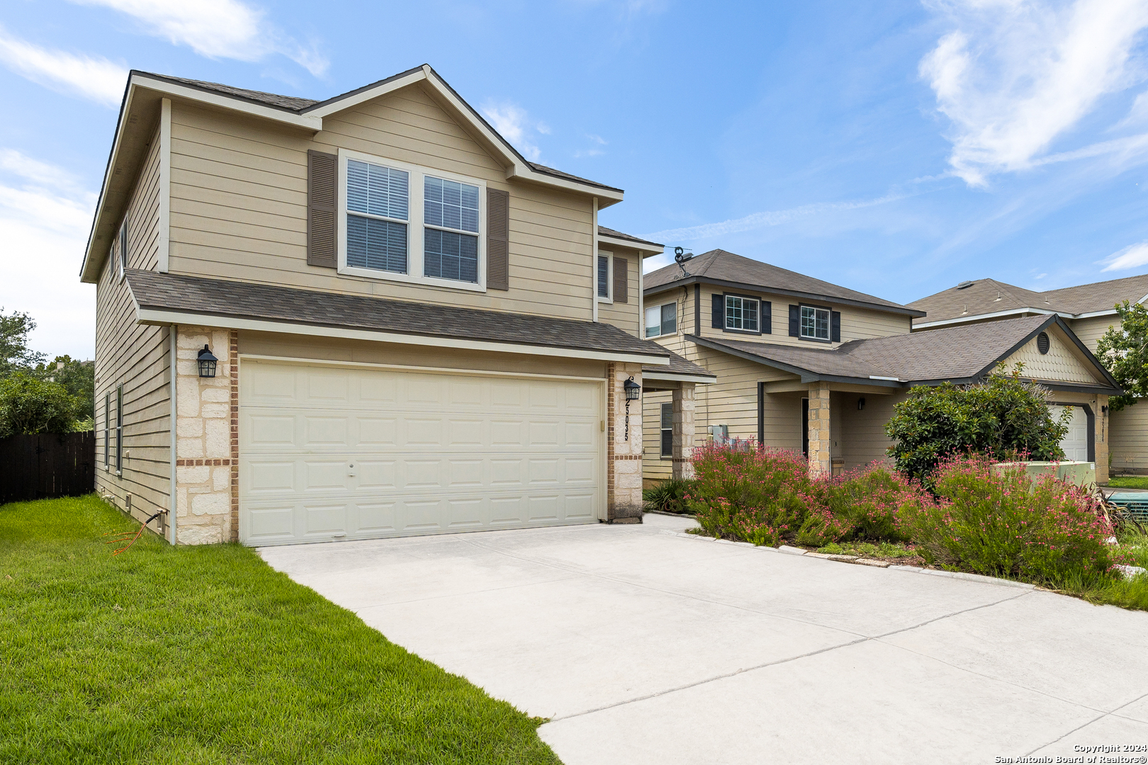 a front view of a house with a yard and garage