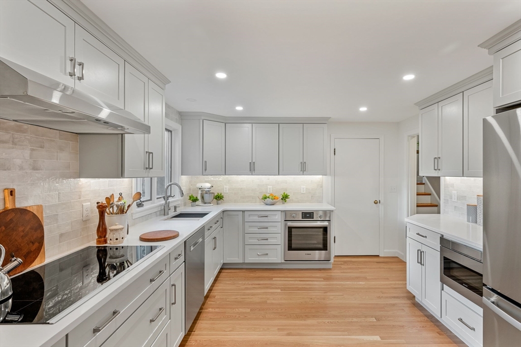 a large kitchen with stainless steel appliances lots of counter space sink and cabinets