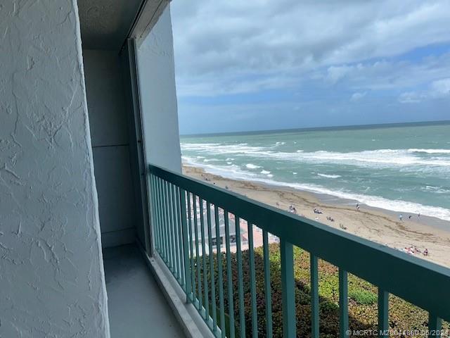 a view of a balcony next to a yard