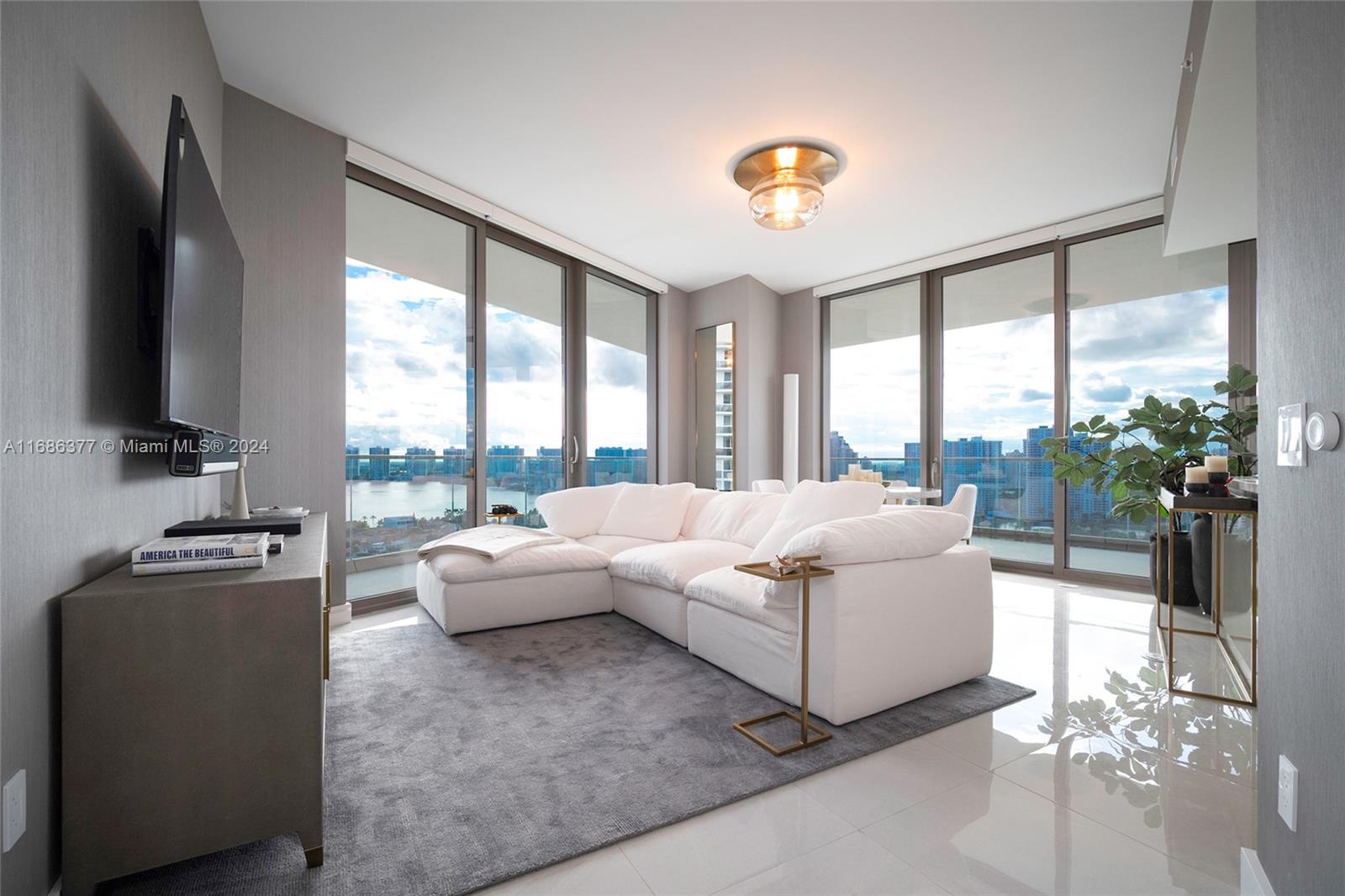 a living room with furniture and a flat screen tv