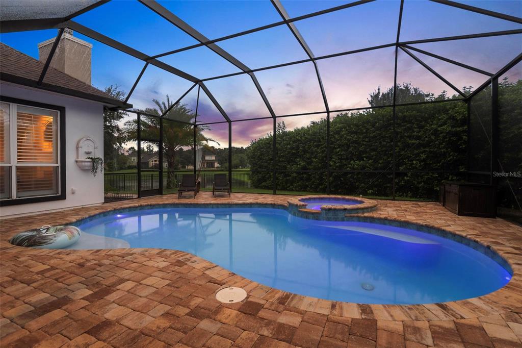 a view of a backyard with a table and chairs under an umbrella