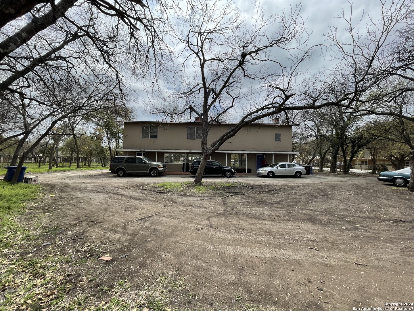 a front view of a building with trees