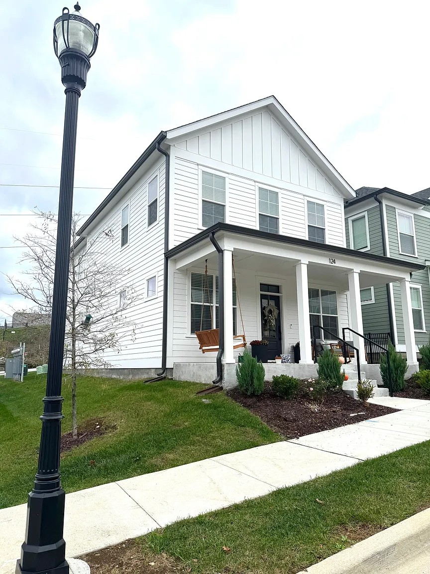 a front view of a house with garden and plants