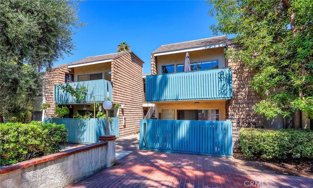 a view of a house with wooden fence