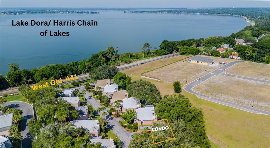 an aerial view of a house with a yard and lake view