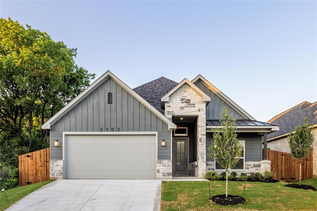 a view of a house with yard and a garage