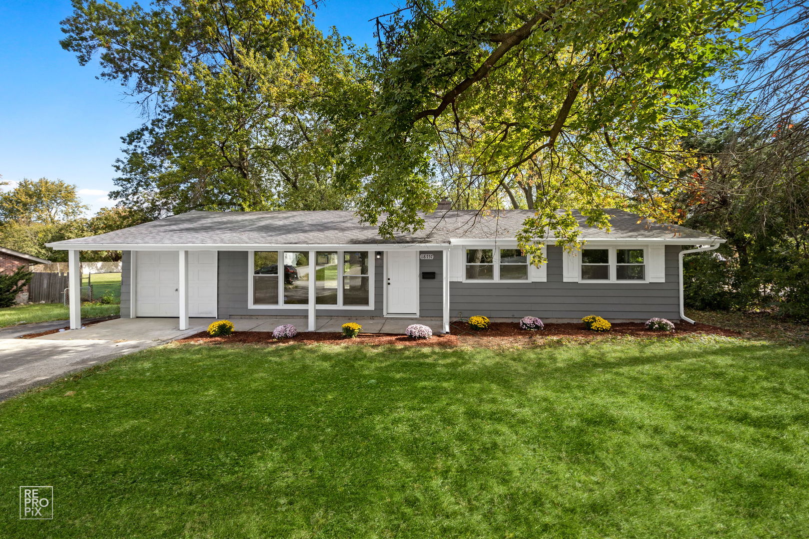 front view of a house with a backyard