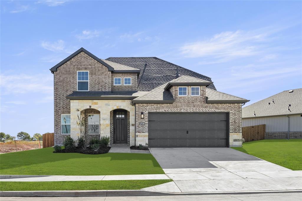 a front view of a house with a yard and garage