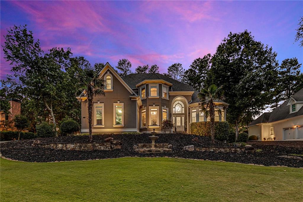 a front view of a house with a garden