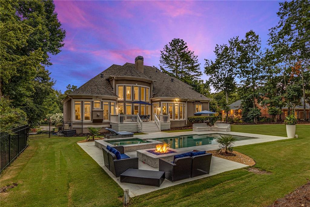 a front view of a house with swimming pool having outdoor seating