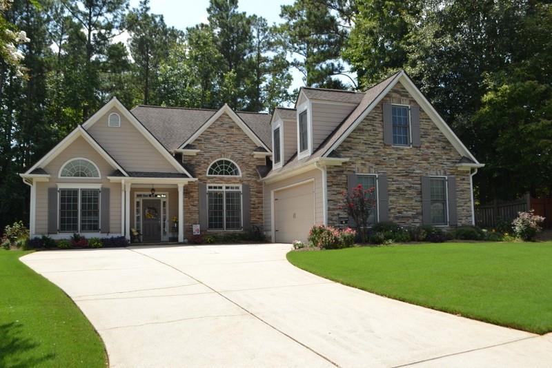 a front view of a house with a garden