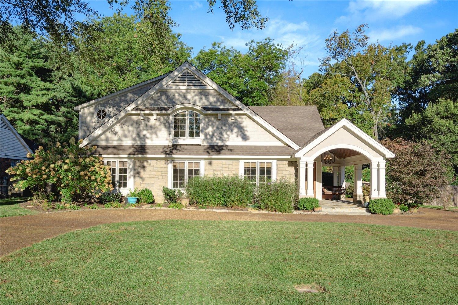 a front view of a house with a garden