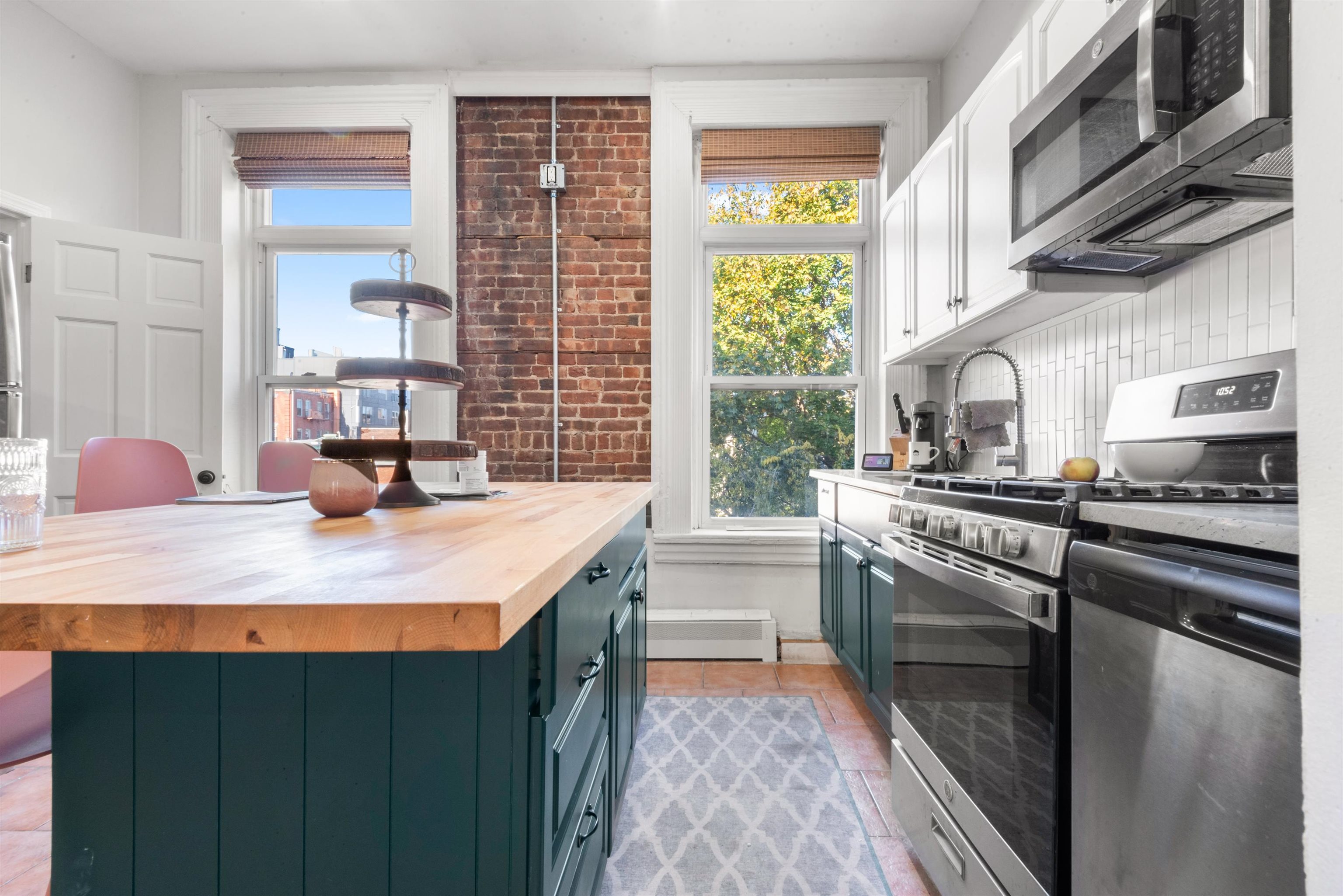 a kitchen with stainless steel appliances kitchen island granite countertop a sink and cabinets