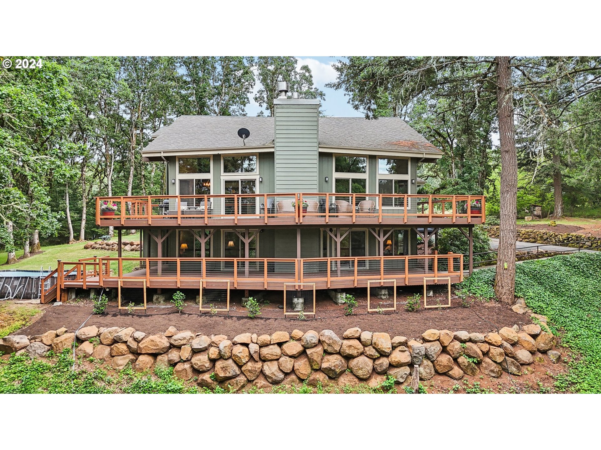 a view of a house with wooden deck