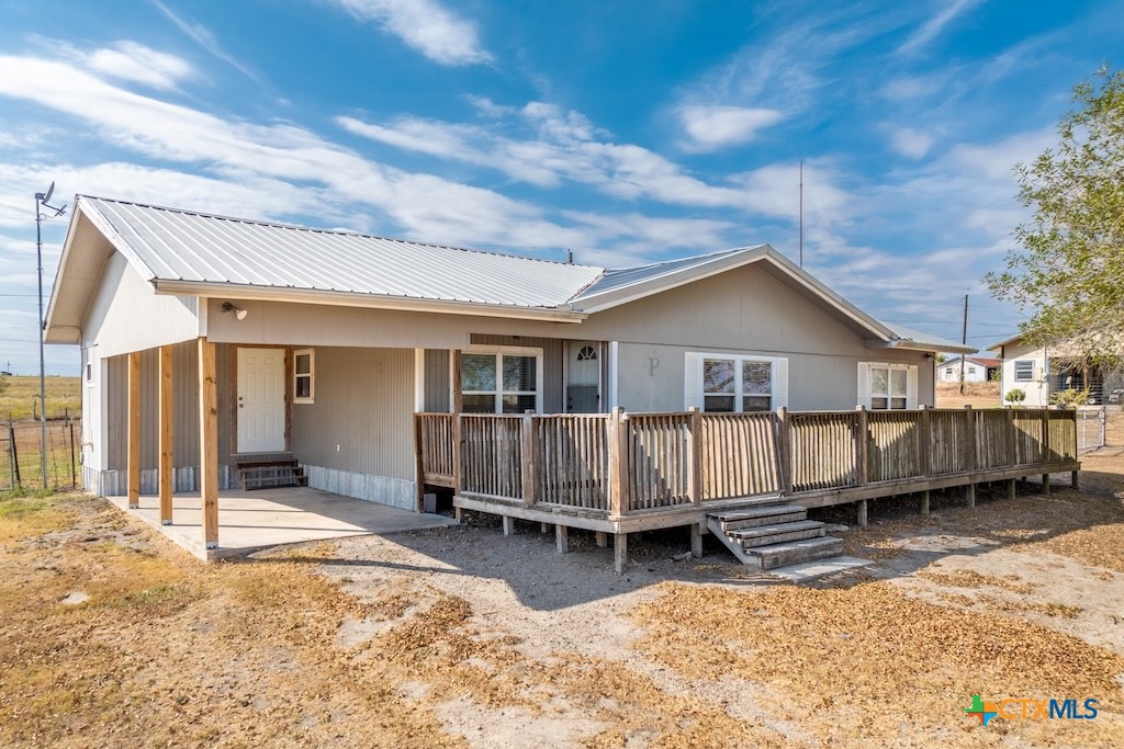 a view of a house with wooden fence