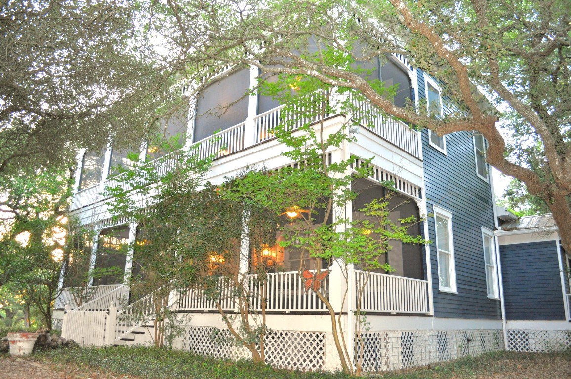 a view of a brick house with a large tree