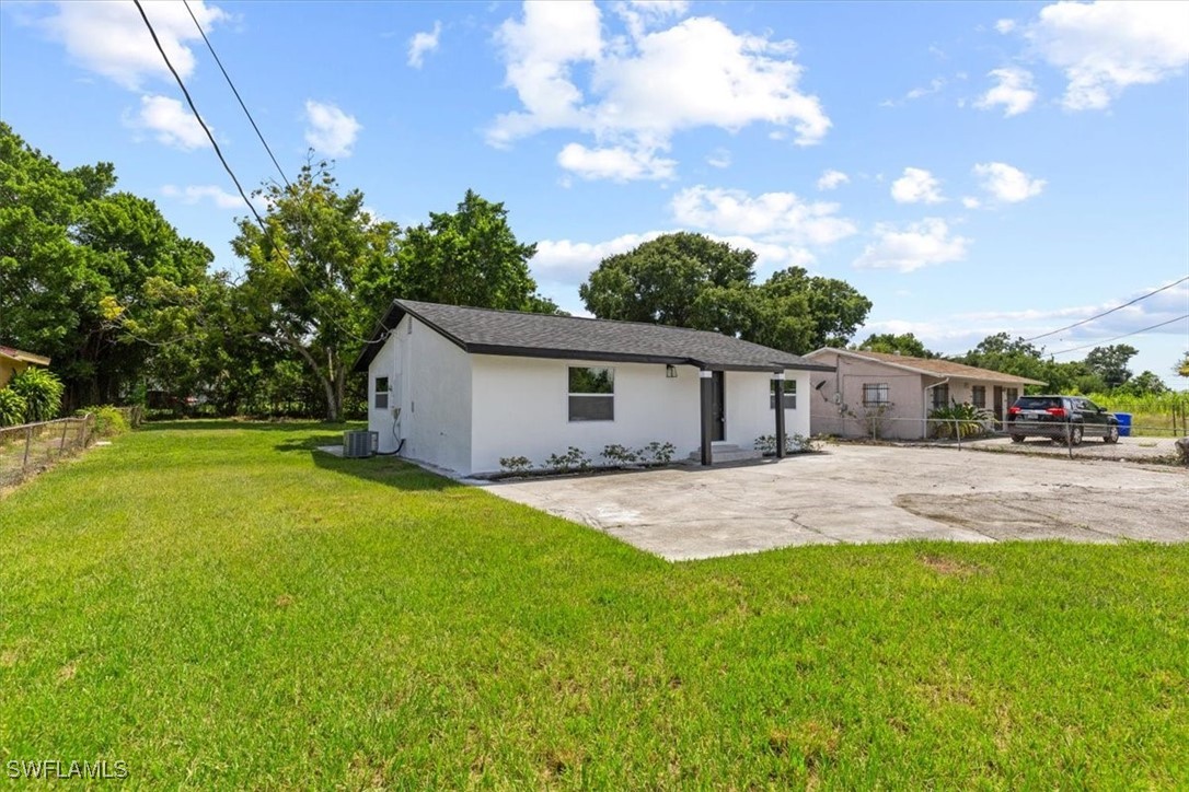 a front view of house with yard and trees