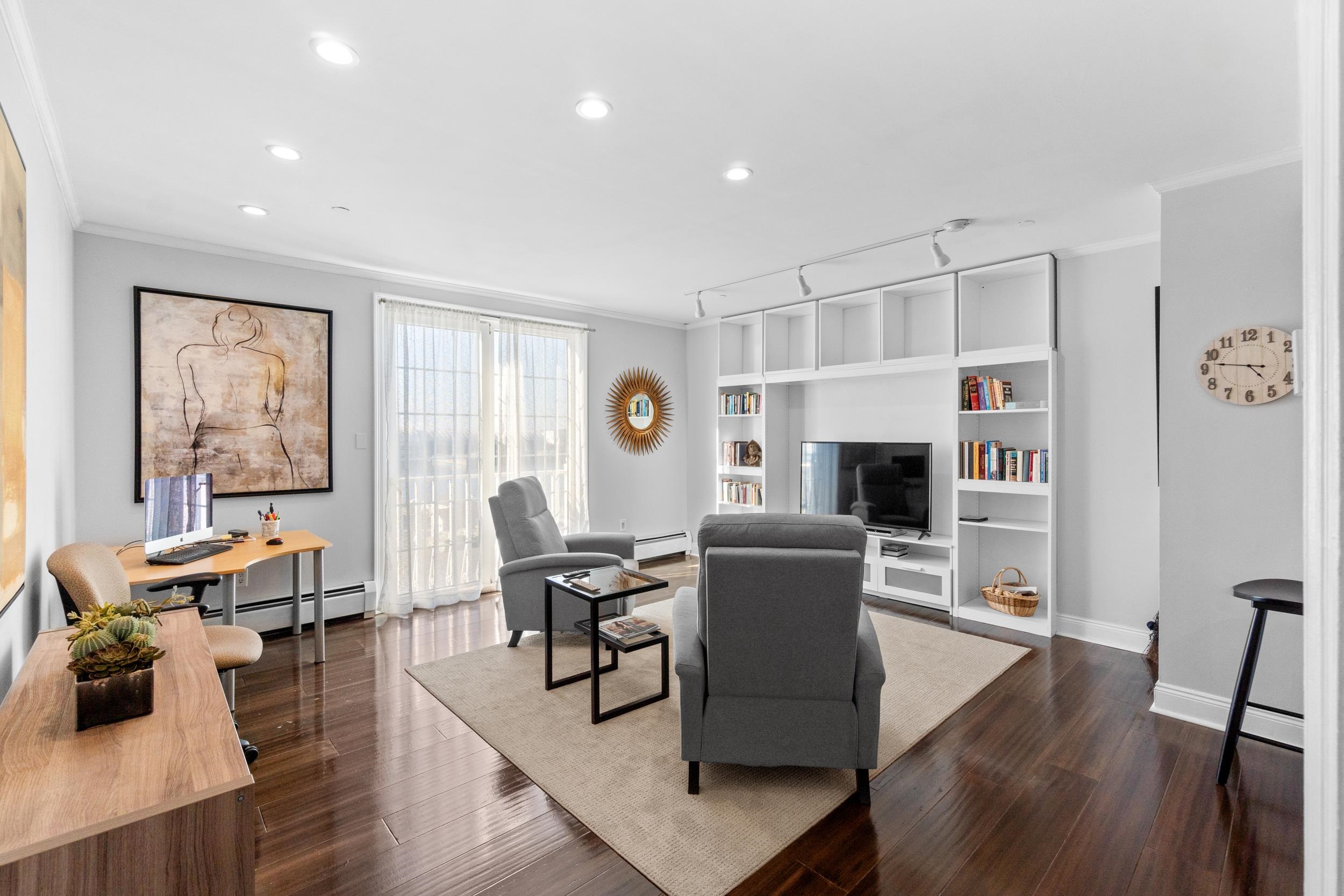 a living room with furniture a fireplace and a wooden floor