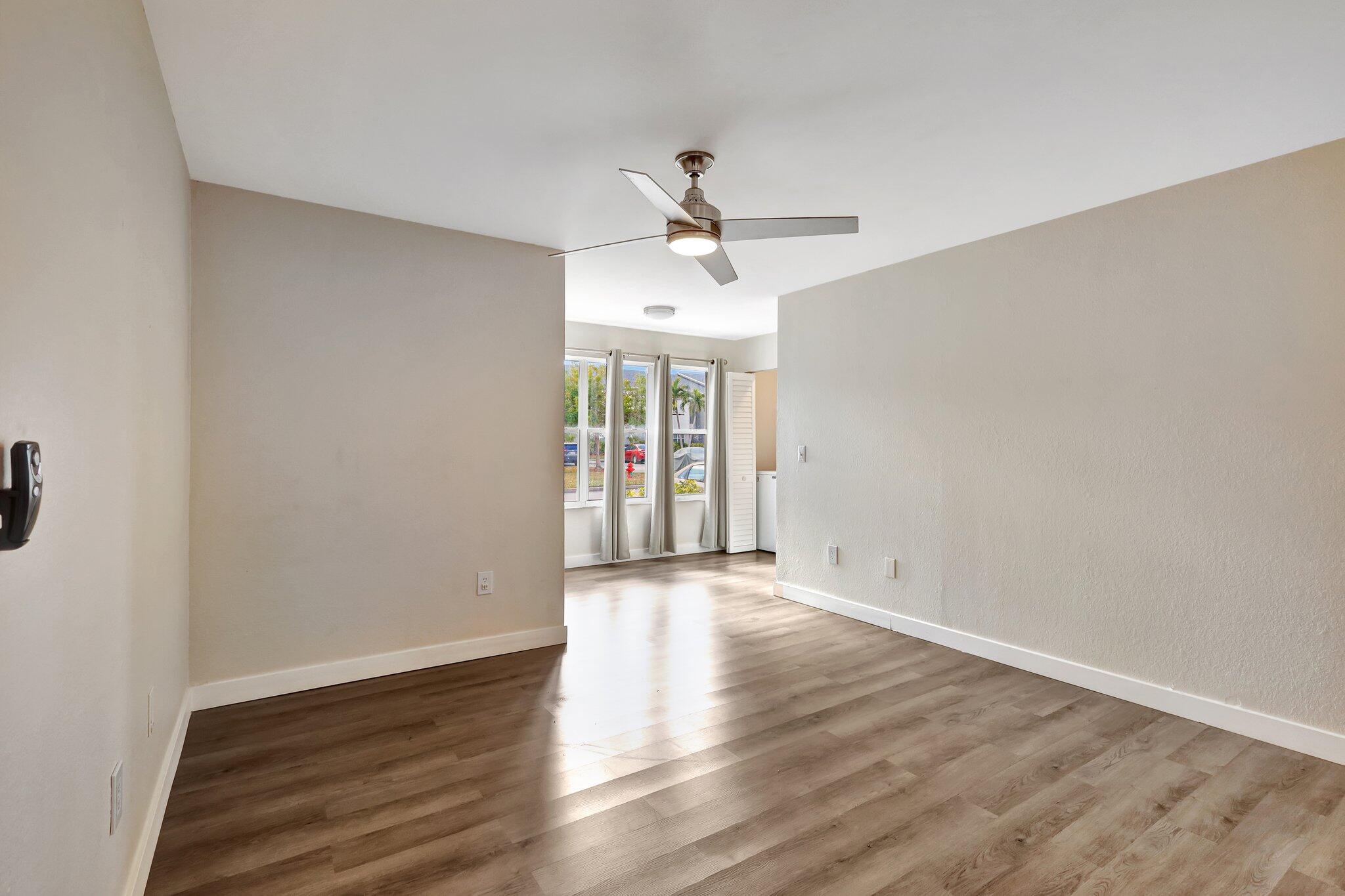 wooden floor in an empty room with a window