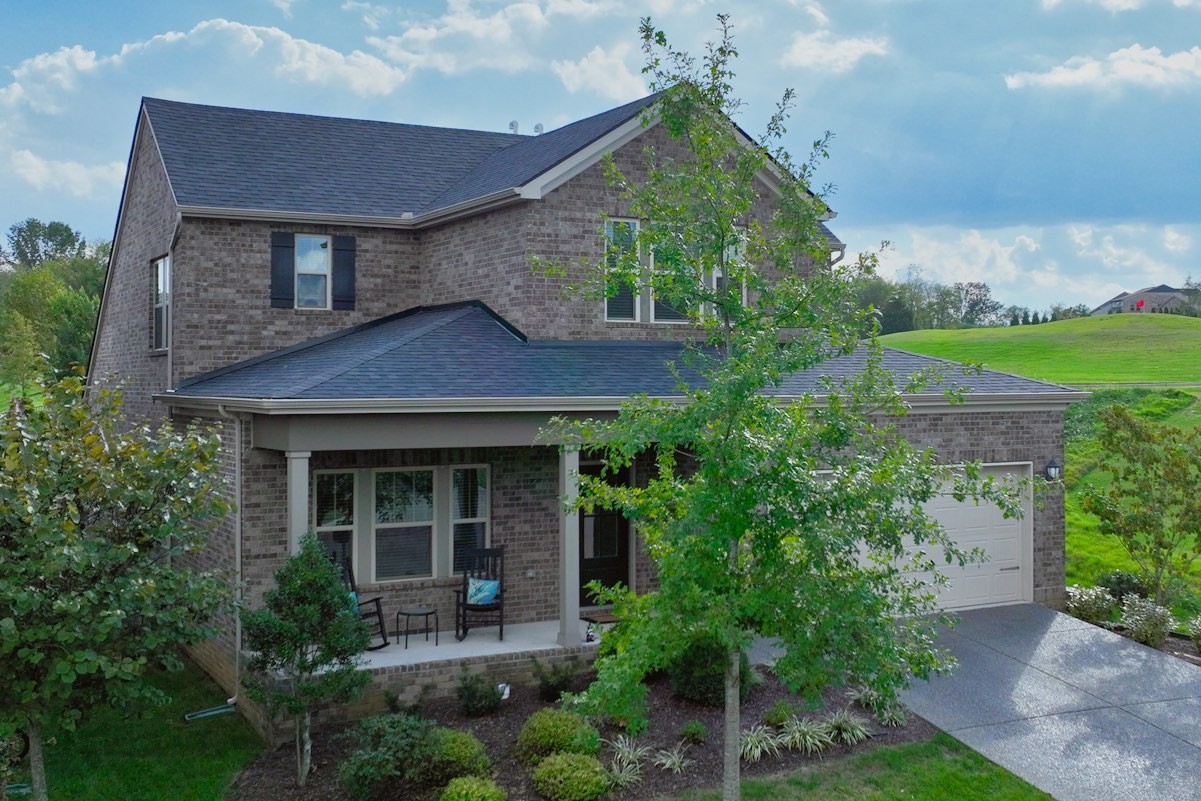 a front view of a house with garden