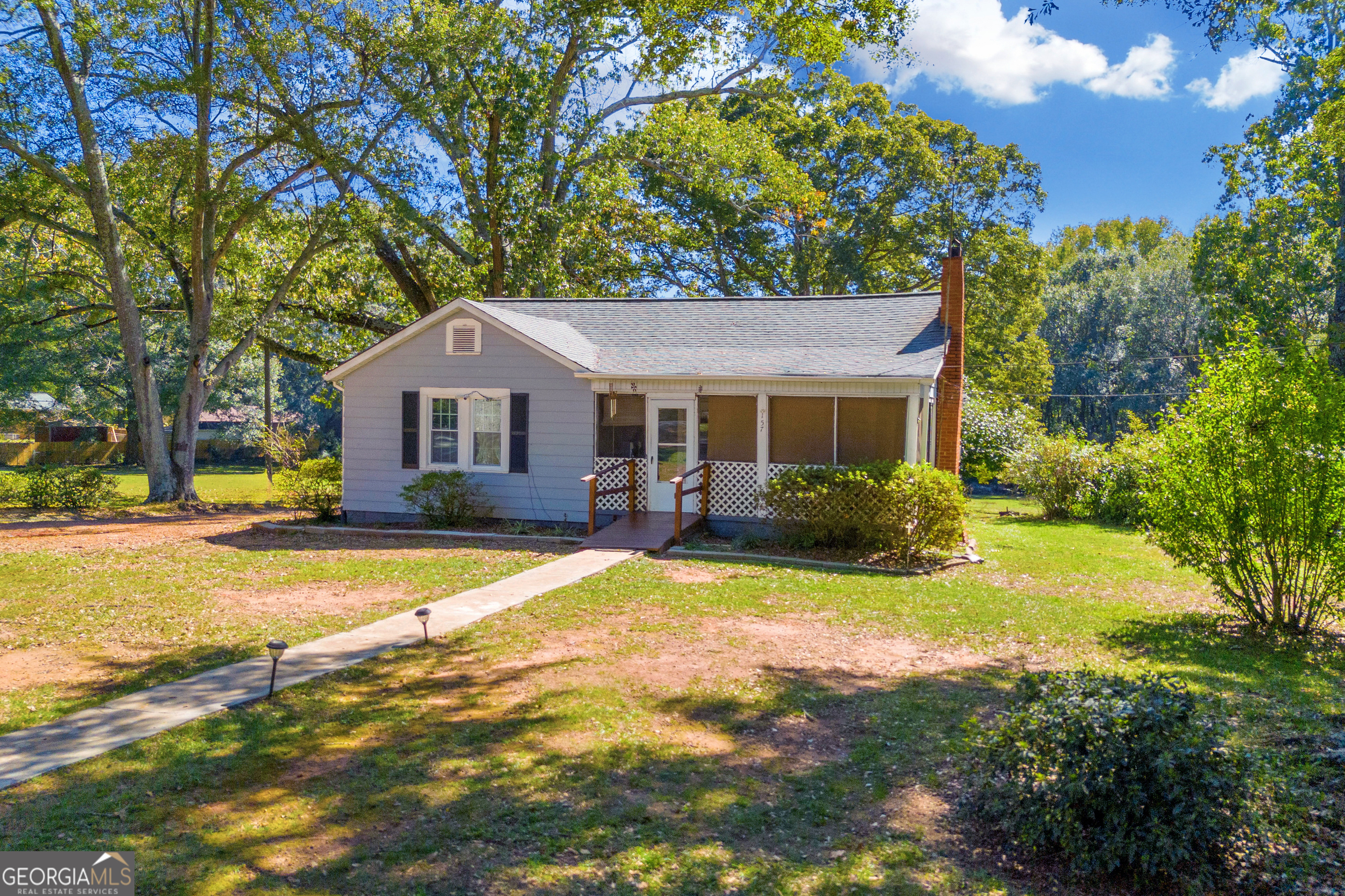 a front view of a house with yard and green space