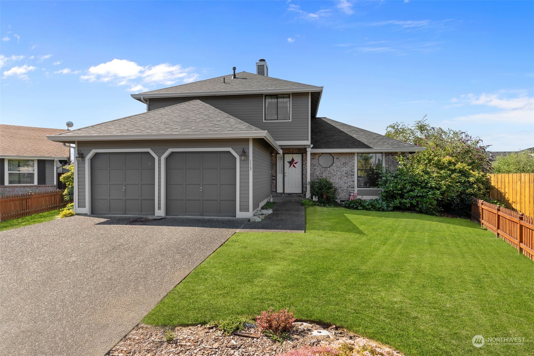 a front view of a house with a garden