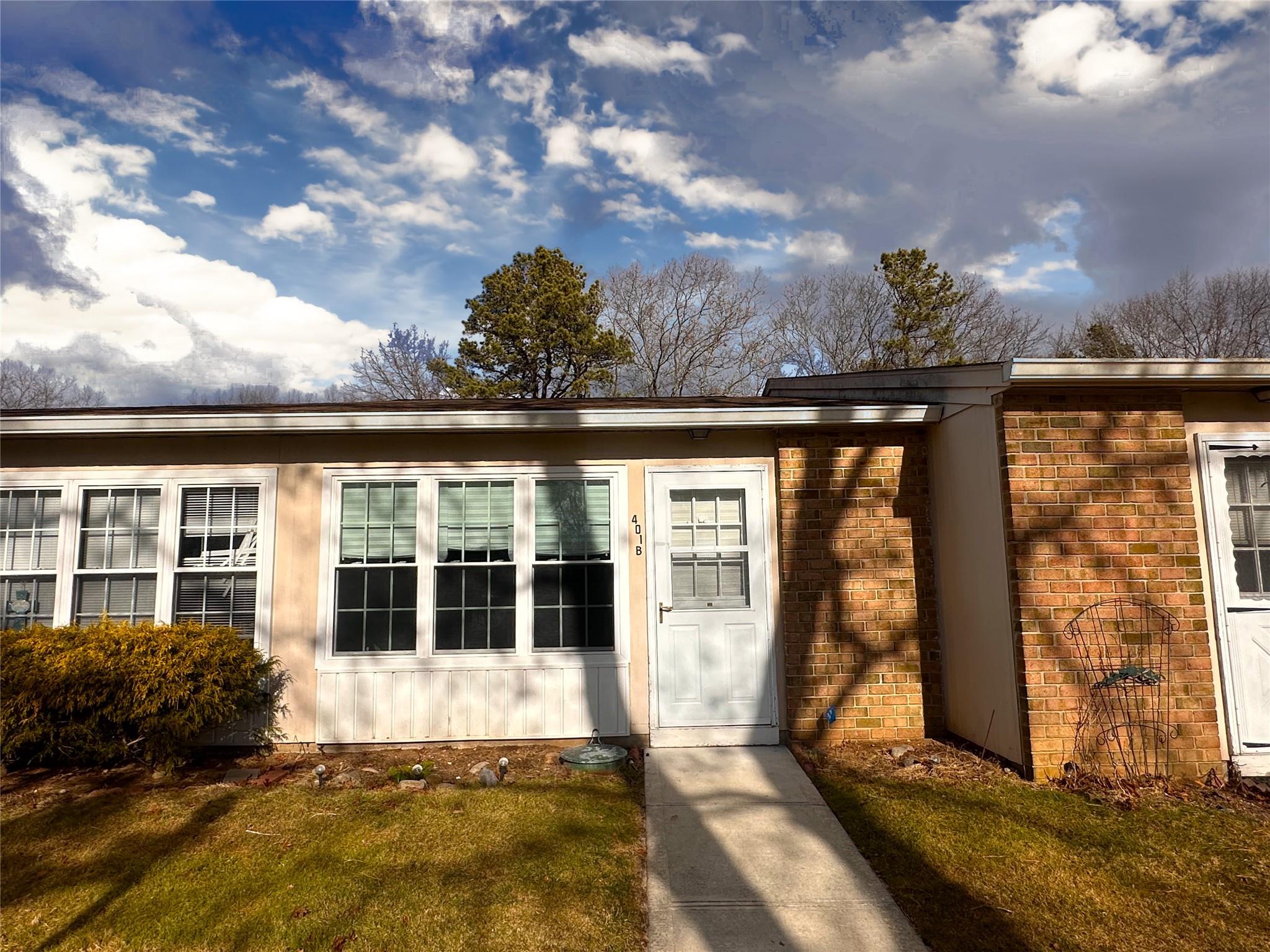 a view of a house with a large window and a yard