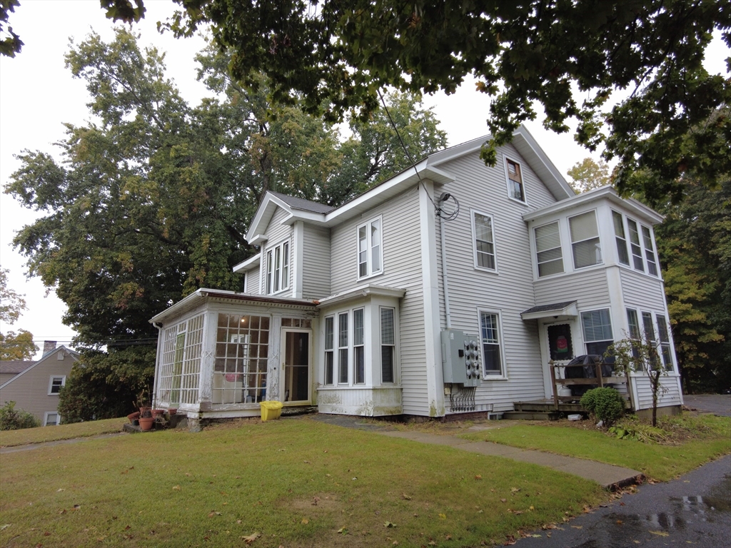 a front view of a house with a garden