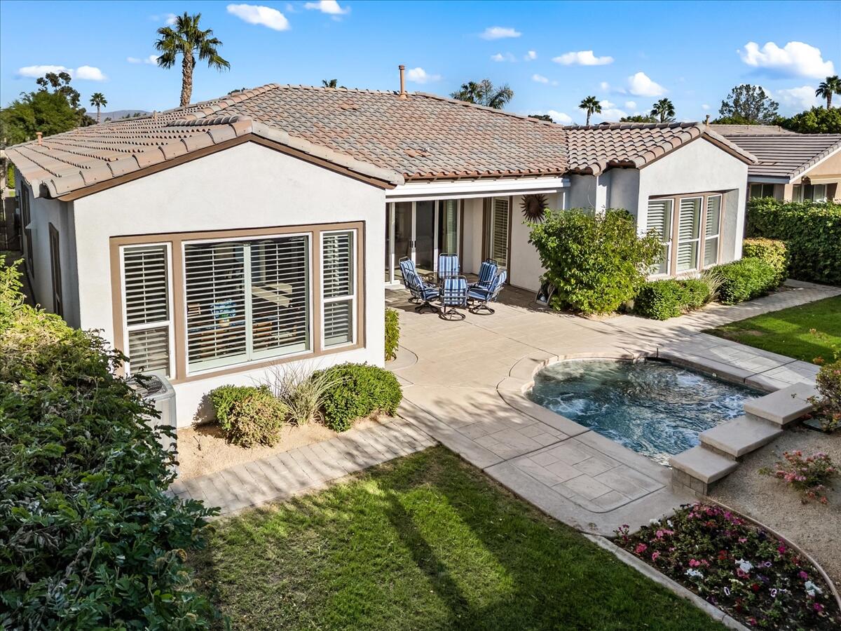 a front view of a house with a yard and potted plants