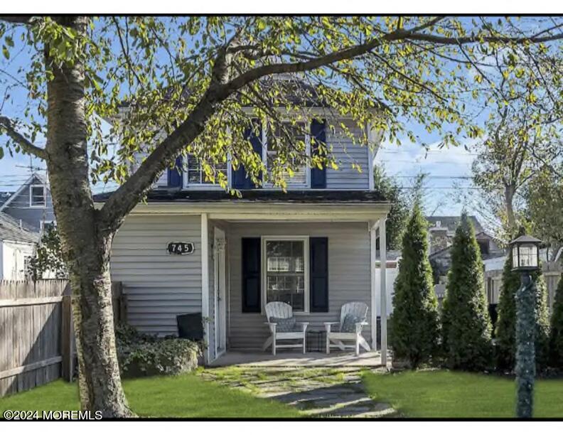 a view of a house with a yard and sitting area