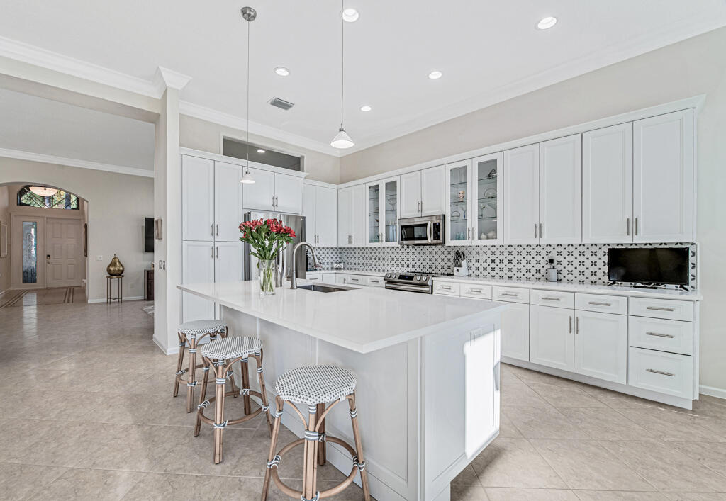 a kitchen with stainless steel appliances kitchen island granite countertop a sink and cabinets