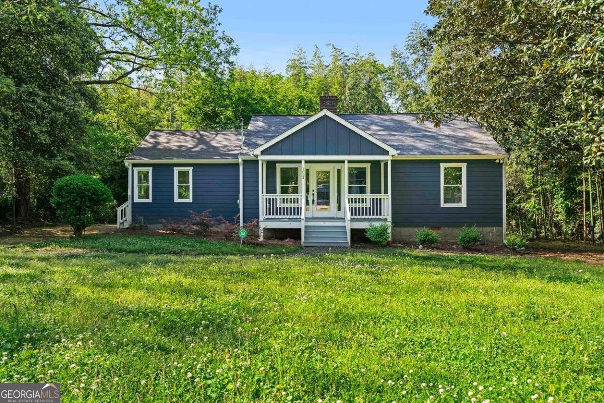 a front view of a house with a garden